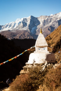 Temple with prayer flag, mountains in the background Temple with prayer flag, mountains in the background